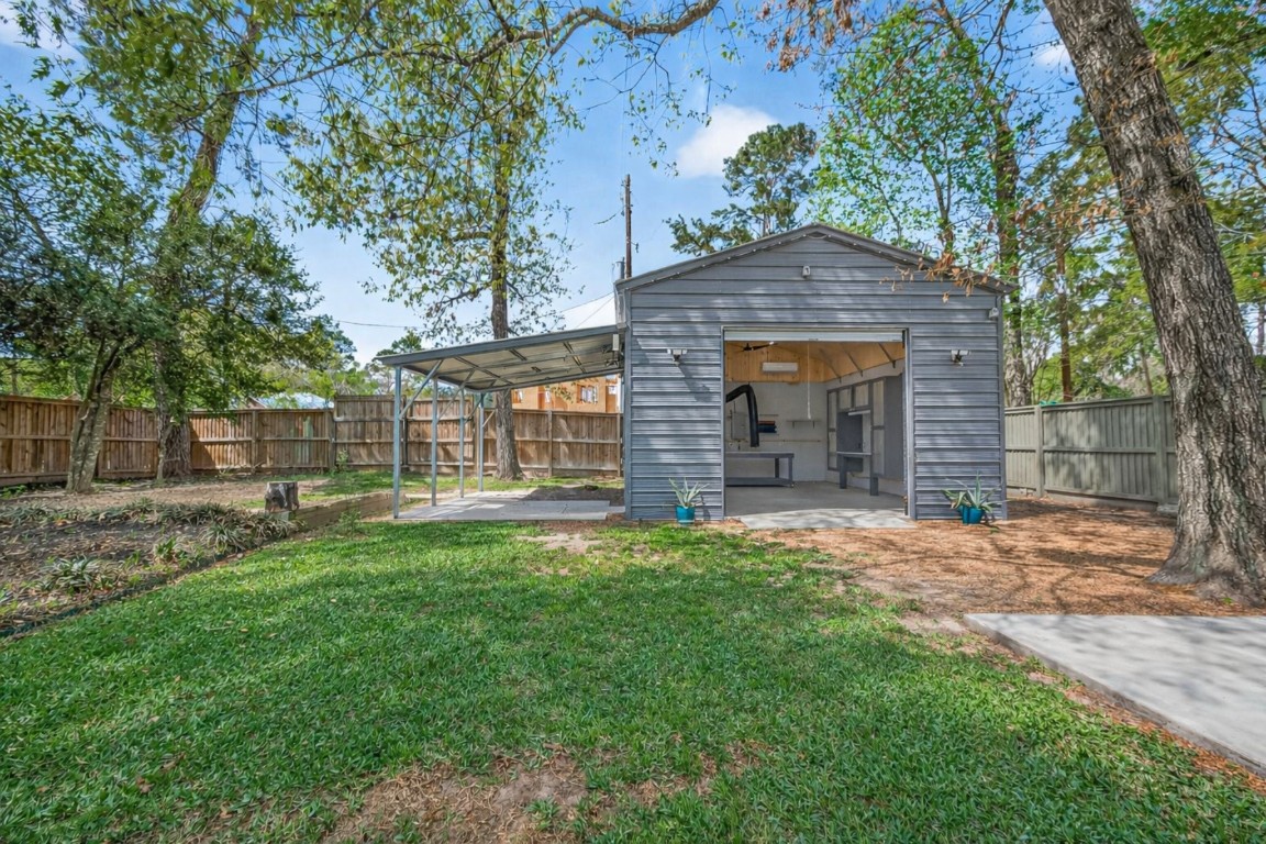 1619 Ashway Street Conroe, TX 77385 - Photo 28 of 40 Hobbyists will love this 22x23 workshop with 10x10 roll up door. Climate controlled (A/C and heat) via mini split. It has a 200 amp system with 6 220V outlets and is wired for internet. Elevated RV parking pad has it's own gate.