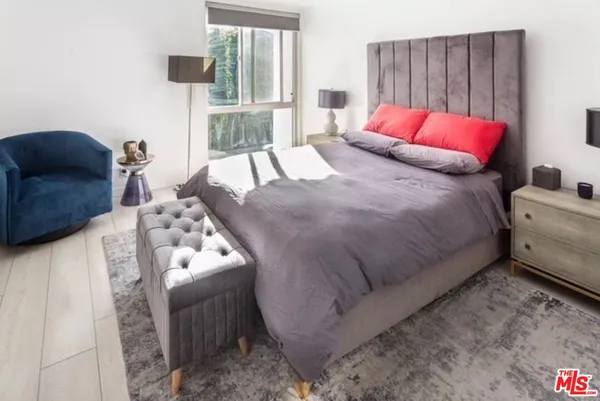 a bedroom with a bed and window