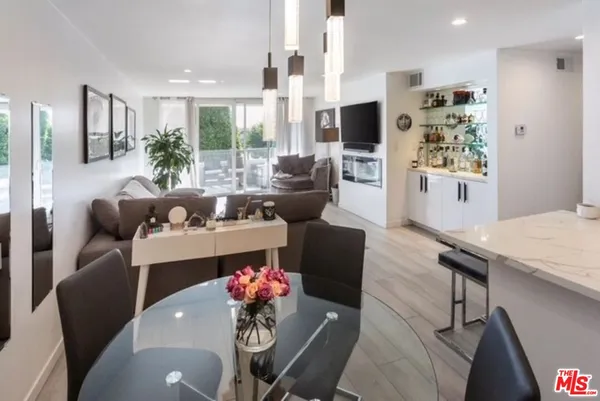 a living room with fireplace furniture and a large window