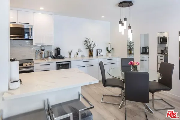 a kitchen with a table chairs stove and microwave