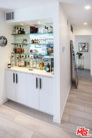 a room with stainless steel appliances granite countertop a refrigerator and a sink