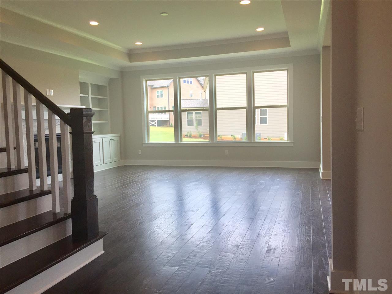 5248 Aleppo Lane, Unit 47 Raleigh, NC 27613 - Photo 14 of 19 a view of an empty room with wooden floor and a window