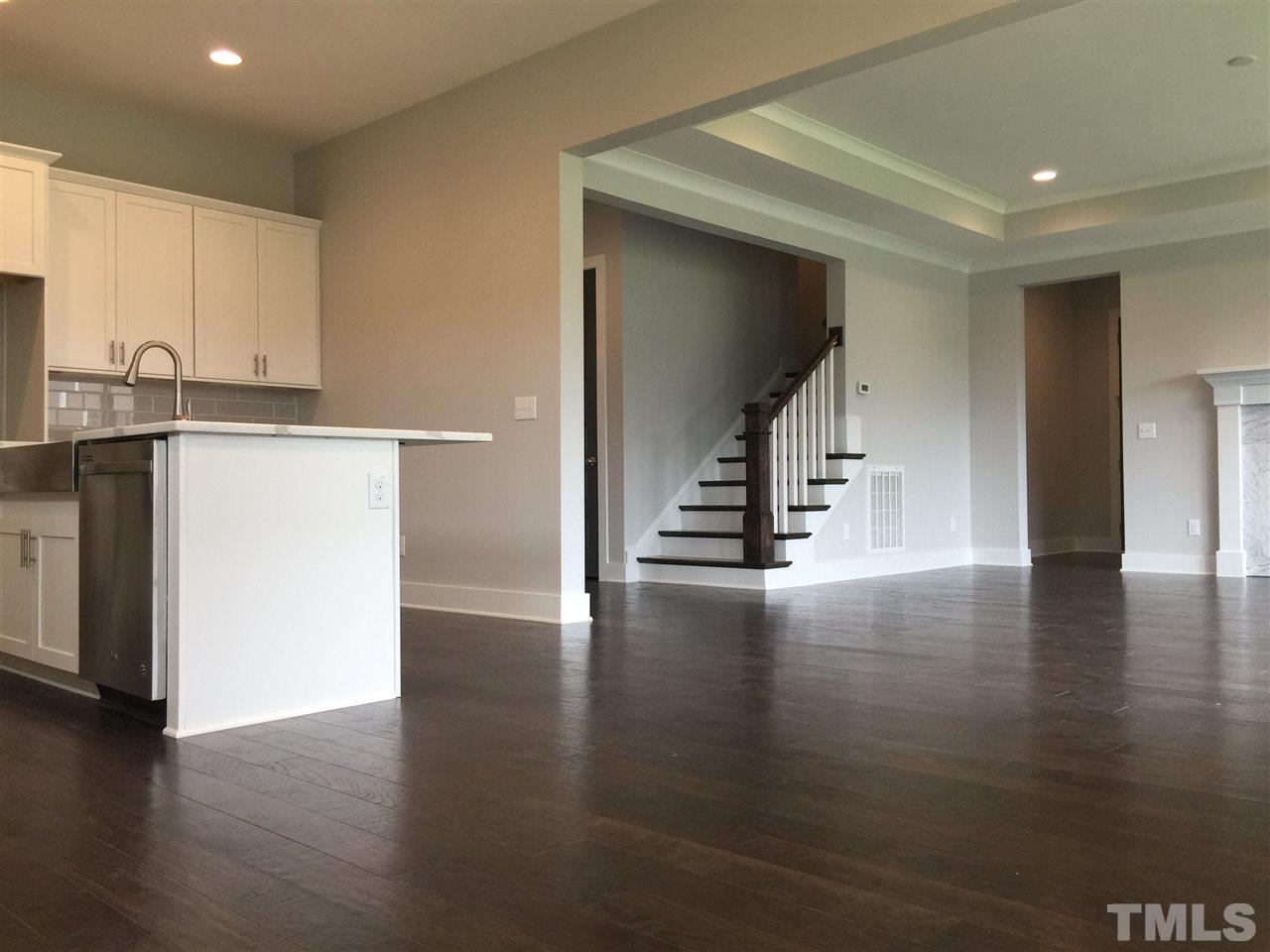 5248 Aleppo Lane, Unit 47 Raleigh, NC 27613 - Photo 8 of 19 a view of an empty room with wooden floor and a window