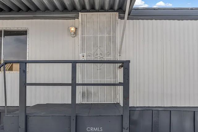 a view of a patio with a dining table and chairs with wooden floor