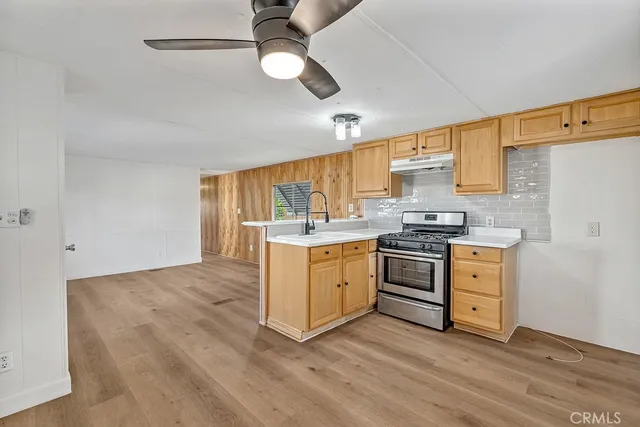 a kitchen with stove cabinets and wooden floor