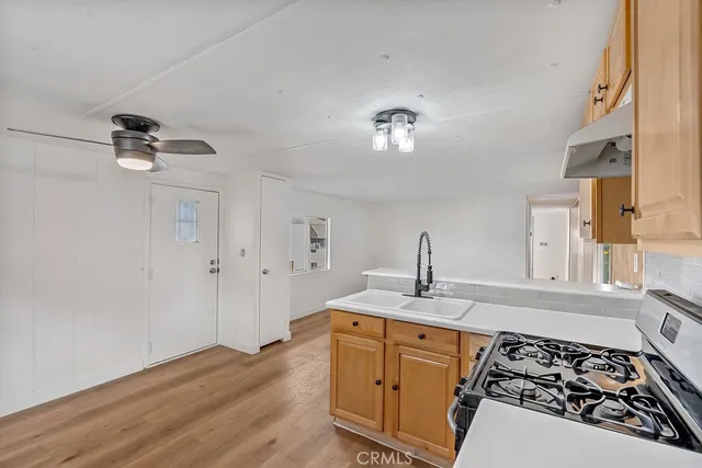a kitchen with a sink appliances and cabinets