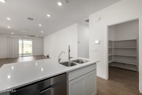 an empty room with a window and a fan