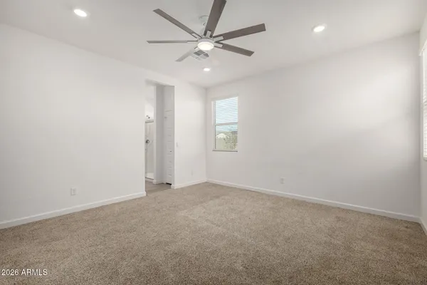 an empty room with fan and a ceiling fan