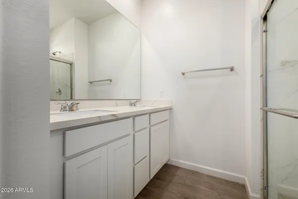 a bathroom with a glass shower door