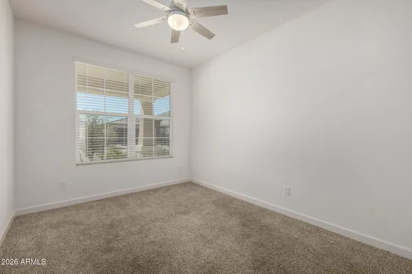 an empty room with a empty space and a ceiling fan