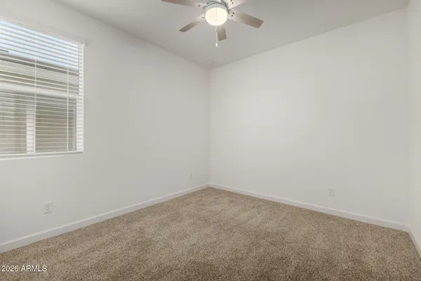 an empty room with a ceiling fan
