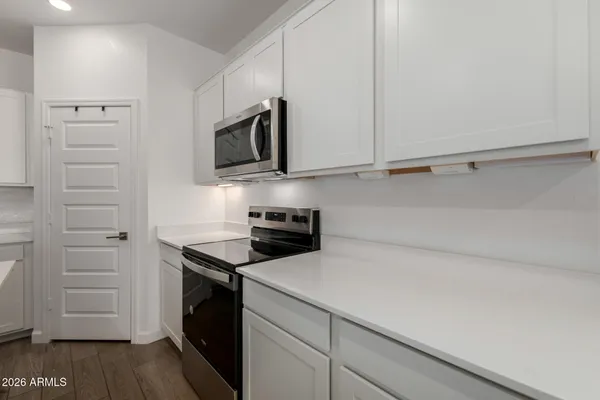 a kitchen with stainless steel appliances a stove microwave and sink