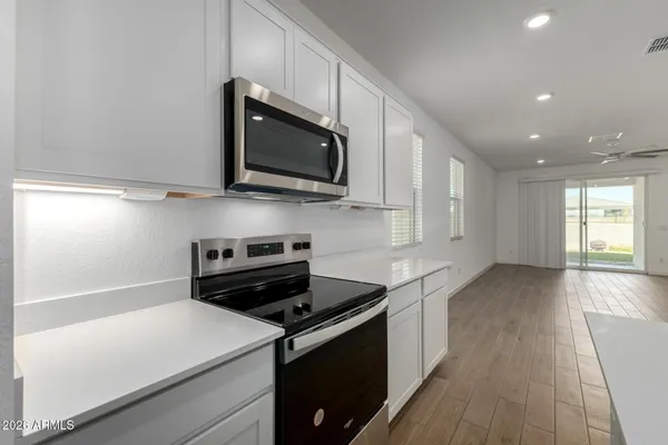 a kitchen with a refrigerator and a stove