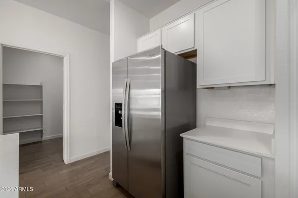 a view of a kitchen island a sink wooden floor and a living room