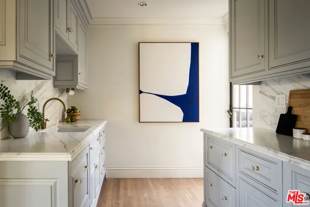a kitchen with stainless steel appliances granite countertop a sink and a microwave