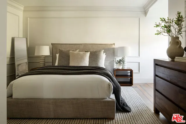a bedroom with a bed and a potted plant