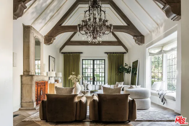 a living room with furniture and a chandelier