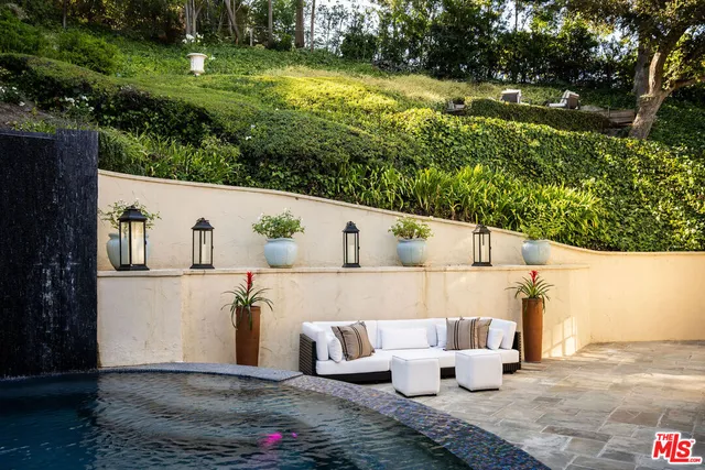 an aerial view of a house with swimming pool and garden