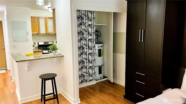 a kitchen with a refrigerator and a chair