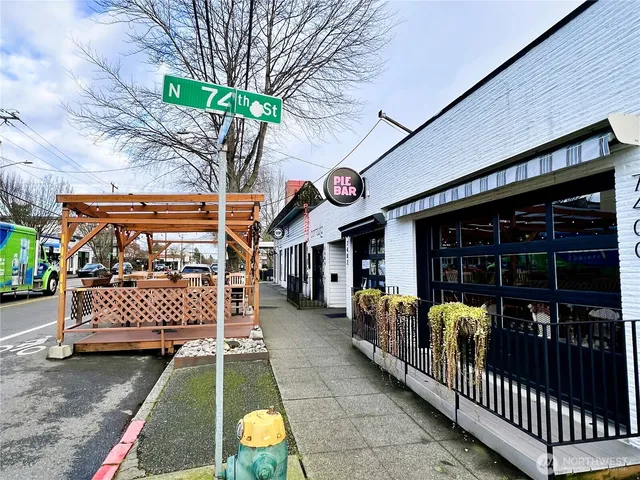 a view of a chairs setting on the deck in front of retail shop