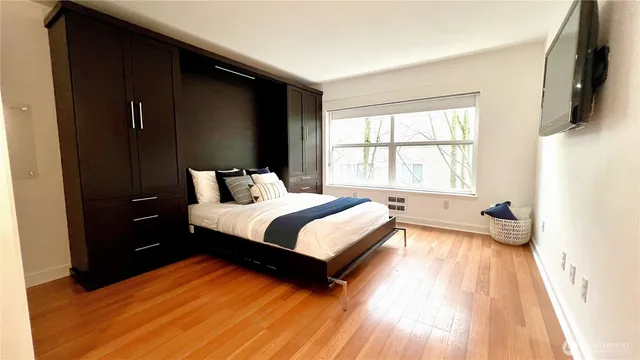 a bedroom with a bed and a window