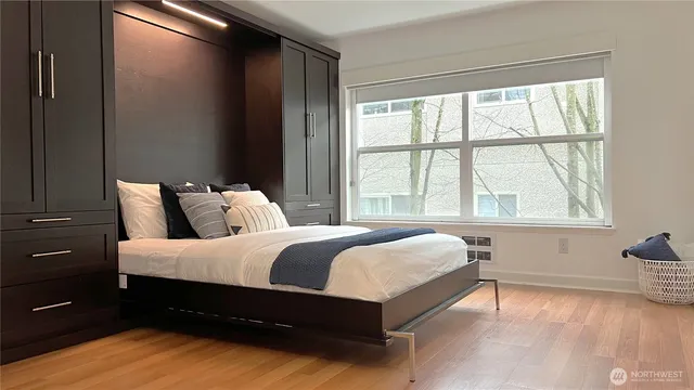 a bed sitting in a bedroom next to a window