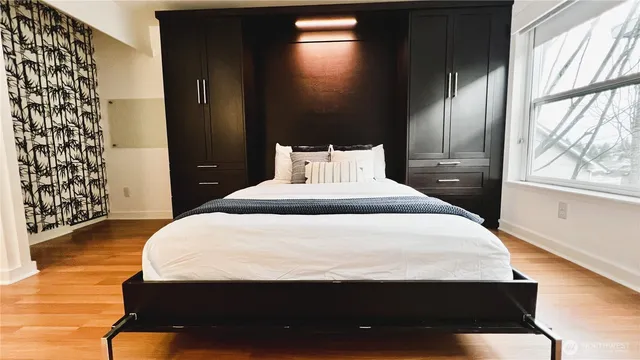 a bedroom with a bed and wooden floor
