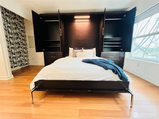 a bedroom with a bed and a flat tv screen