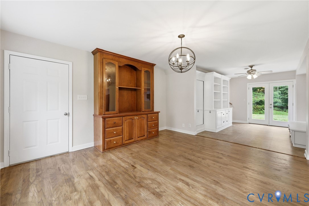 10152 Georgetown Road Mechanicsville, VA 23116 - Photo 12 of 35 an empty room with windows and wooden floor