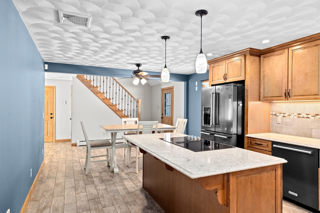 4 Highland Ridge Road Assonet, MA 02702 - Photo 13 of 42 a kitchen view with stainless steel appliances kitchen island granite countertop a sink a stove and a wooden floors