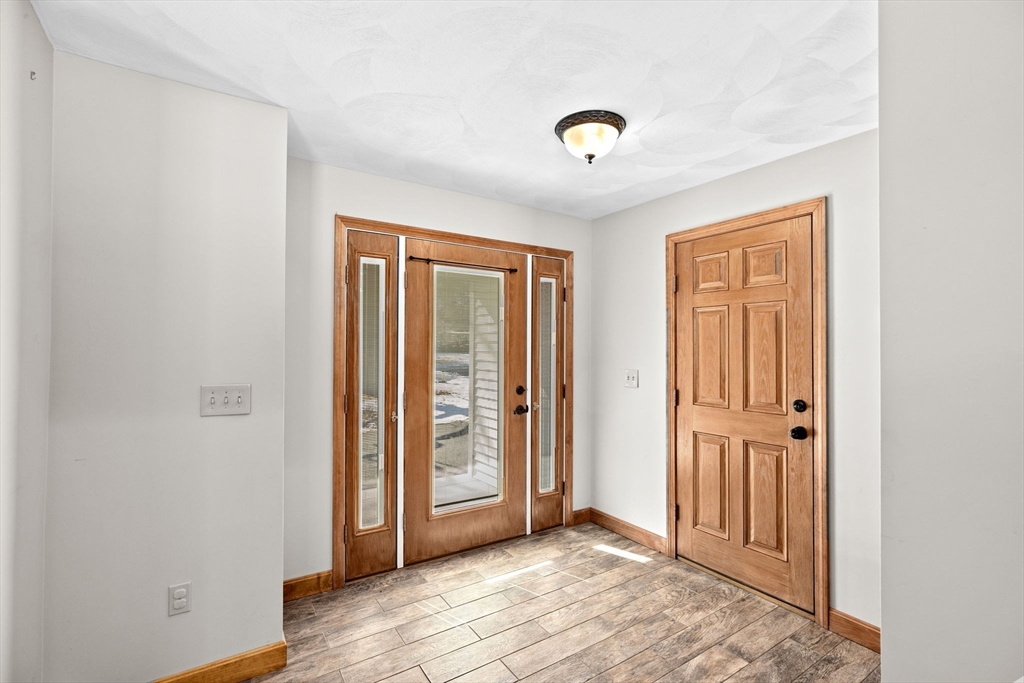 4 Highland Ridge Road Assonet, MA 02702 - Photo 2 of 42 an empty room with wooden floor and windows