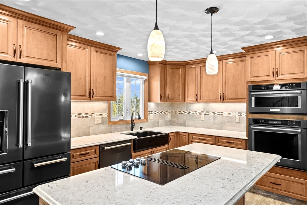 4 Highland Ridge Road Assonet, MA 02702 - Photo 9 of 42 a kitchen with a refrigerator a sink a stove and a kitchen island