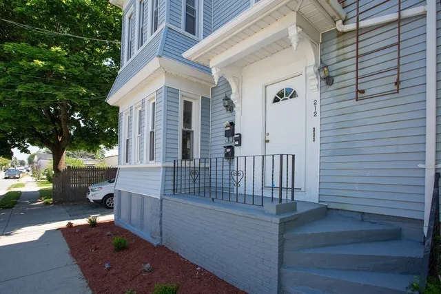 a view of a house with wooden fence