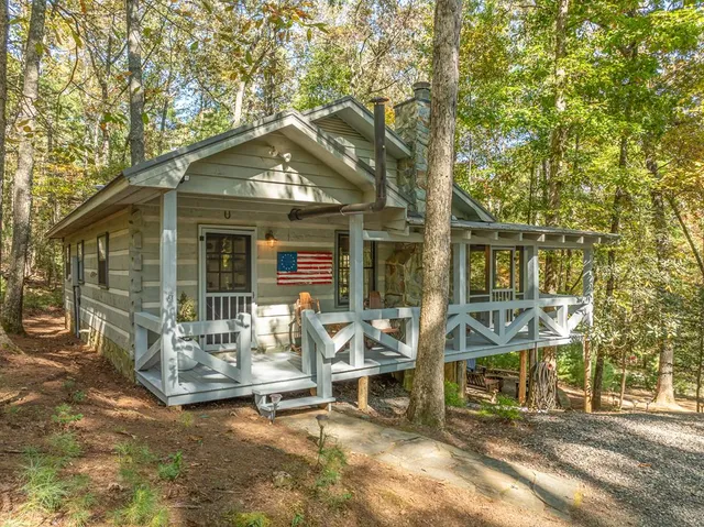 a view of a house with backyard porch and sitting area
