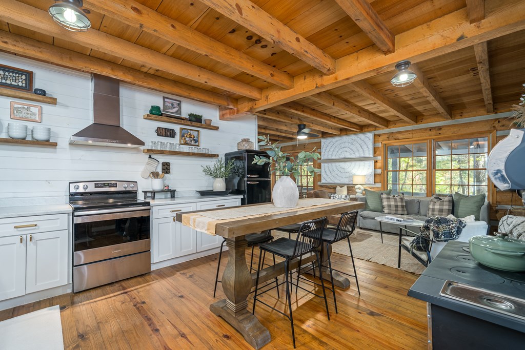 250 Chinkapin Drive Blue Ridge, GA 30513 - Photo 18 of 50 a kitchen with stainless steel appliances a stove a sink dishwasher and cabinets with wooden floor
