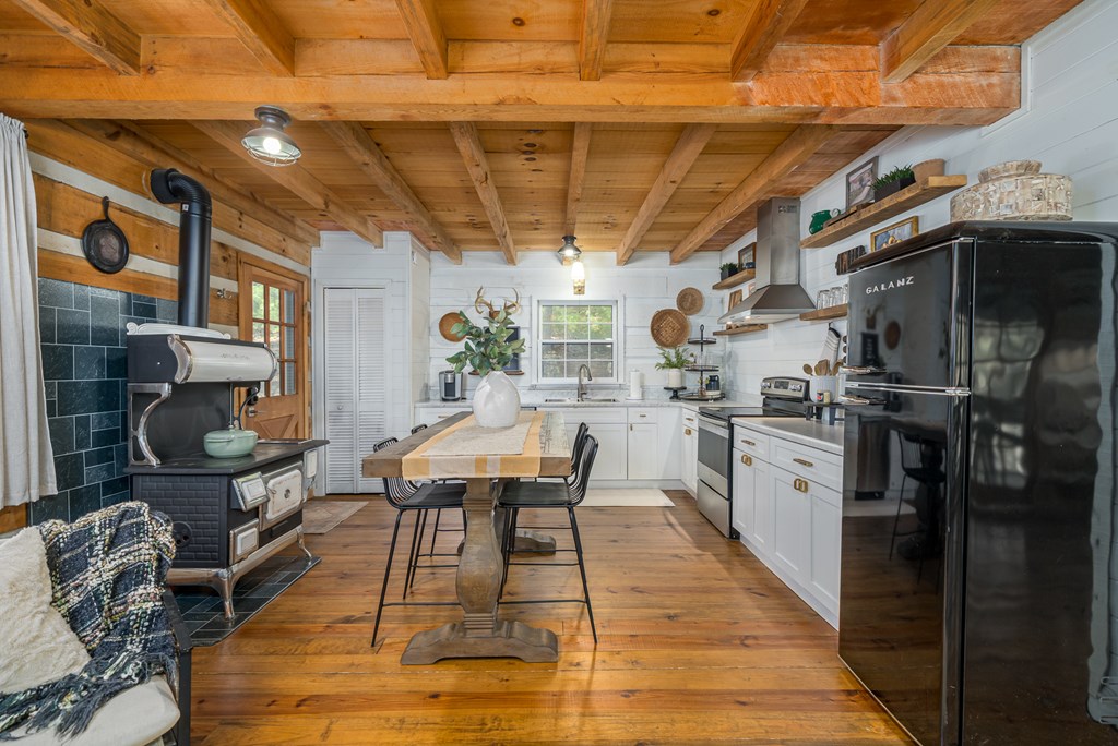 250 Chinkapin Drive Blue Ridge, GA 30513 - Photo 21 of 50 a outdoor dining space with stainless steel appliances kitchen island granite countertop a table chairs in it and a wooden floors