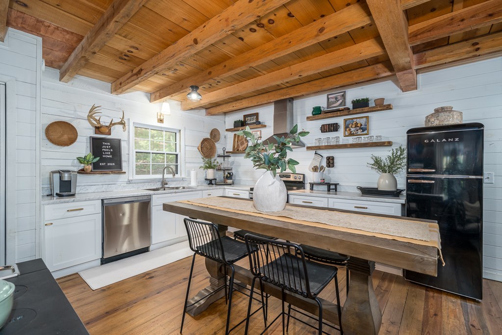 250 Chinkapin Drive Blue Ridge, GA 30513 - Photo 23 of 50 a kitchen with stainless steel appliances granite countertop a sink a stove and cabinets