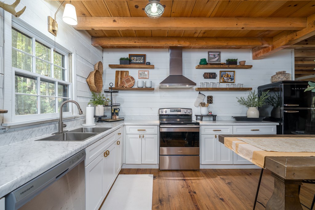 250 Chinkapin Drive Blue Ridge, GA 30513 - Photo 3 of 50 a kitchen with stainless steel appliances granite countertop a sink a stove and a wooden floors