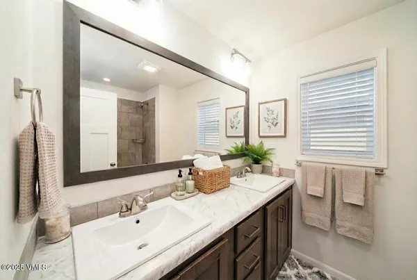 a bathroom with a sink double vanity and a mirror