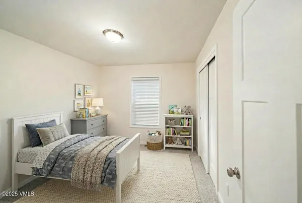 a bedroom with a bed and a view of walk in closet