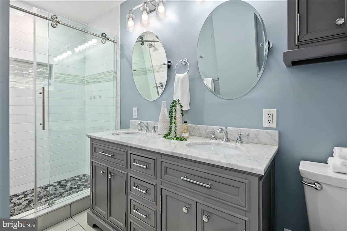 9515 Stevebrook Road Fairfax, VA 22032 - Photo 13 of 25 a bathroom with a granite countertop double vanity sink mirror and shower