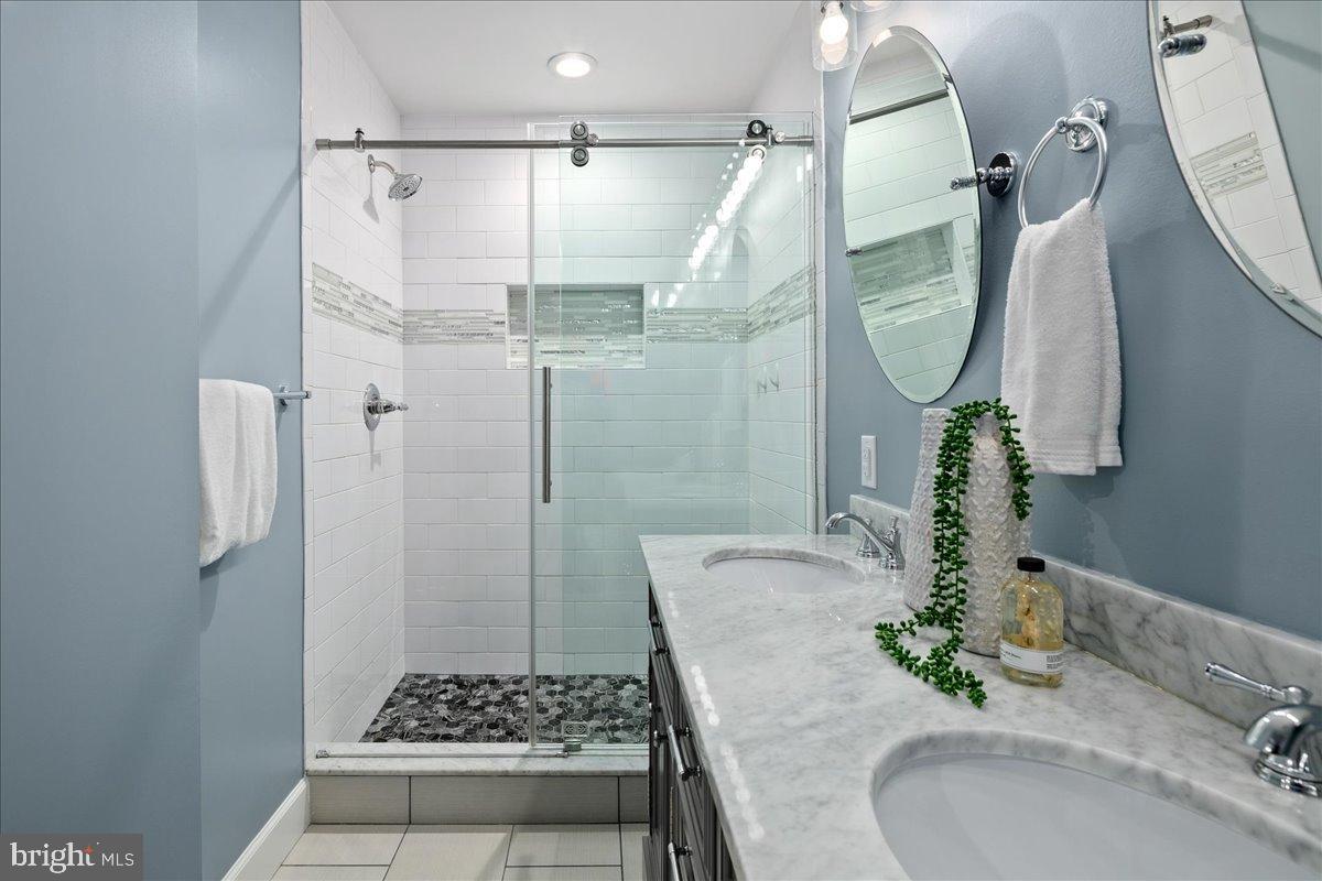 9515 Stevebrook Road Fairfax, VA 22032 - Photo 14 of 25 a bathroom with a granite countertop shower a sink and a mirror