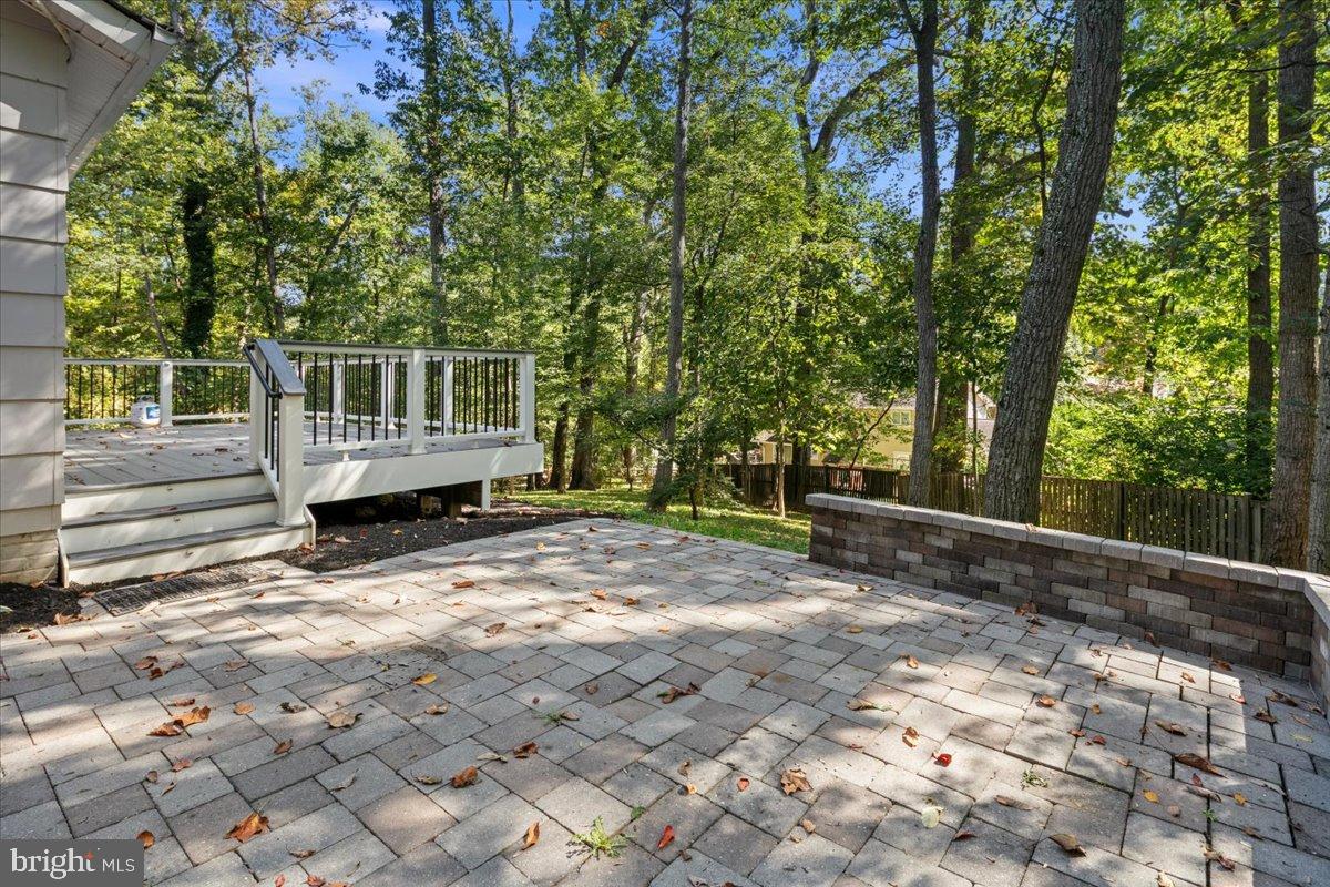 9515 Stevebrook Road Fairfax, VA 22032 - Photo 23 of 25 a view of a wooden deck and a yard with trees