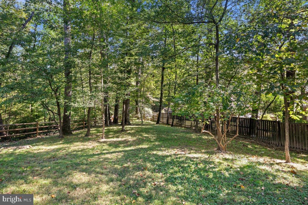 9515 Stevebrook Road Fairfax, VA 22032 - Photo 24 of 25 a backyard of a house with lots of green space and fountain