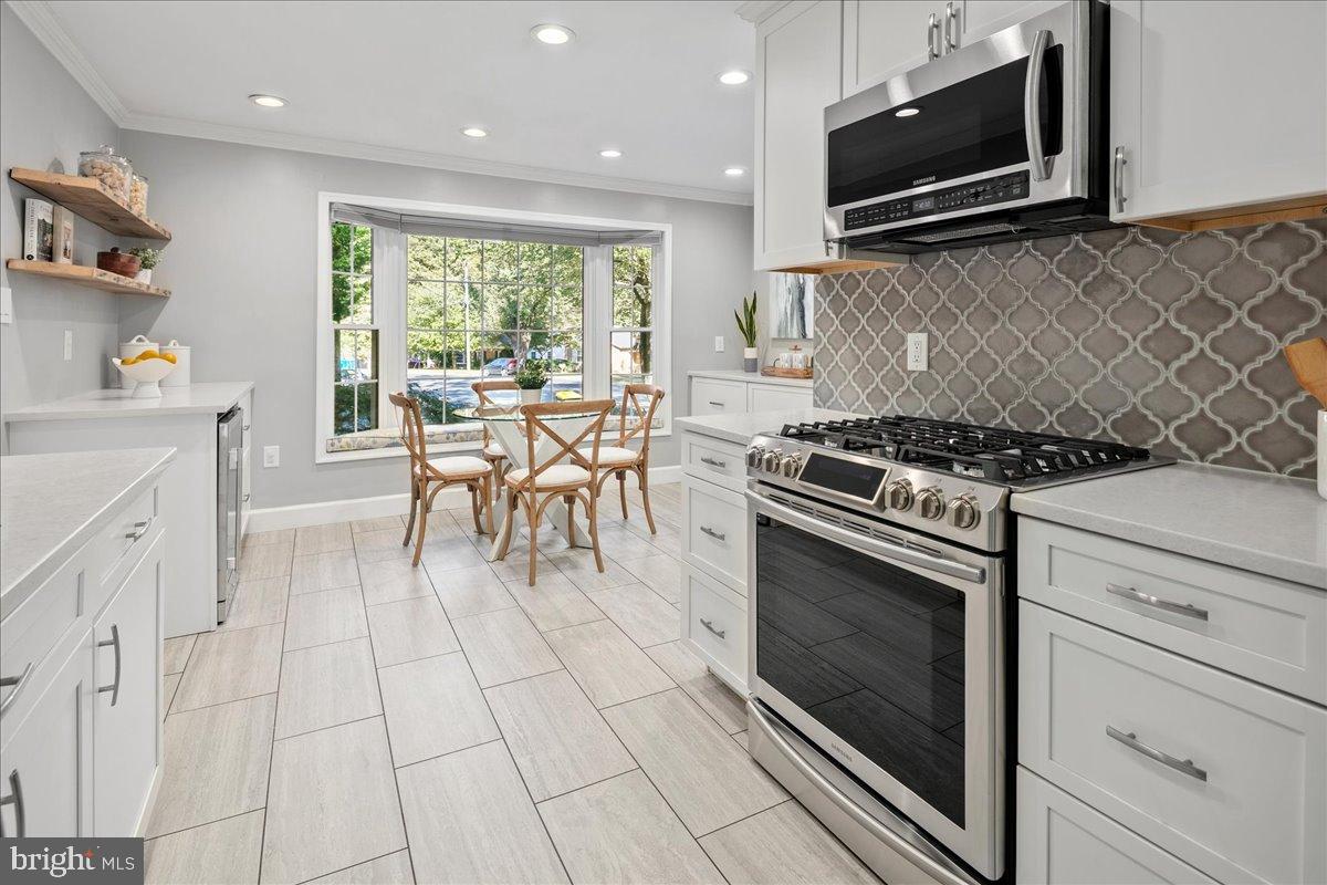 9515 Stevebrook Road Fairfax, VA 22032 - Photo 5 of 25 a kitchen with a stove a sink and a microwave