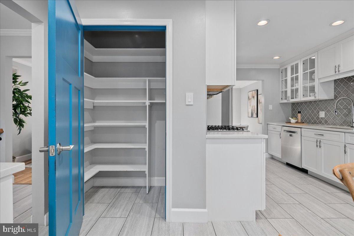 9515 Stevebrook Road Fairfax, VA 22032 - Photo 8 of 25 a kitchen with a refrigerator and white cabinets