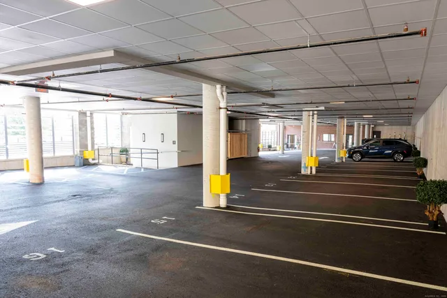 a front view of a brick building with a yard