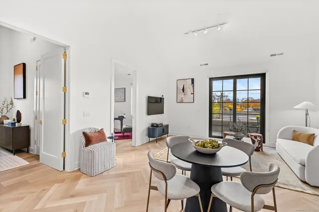 a view of a dining room with furniture and window