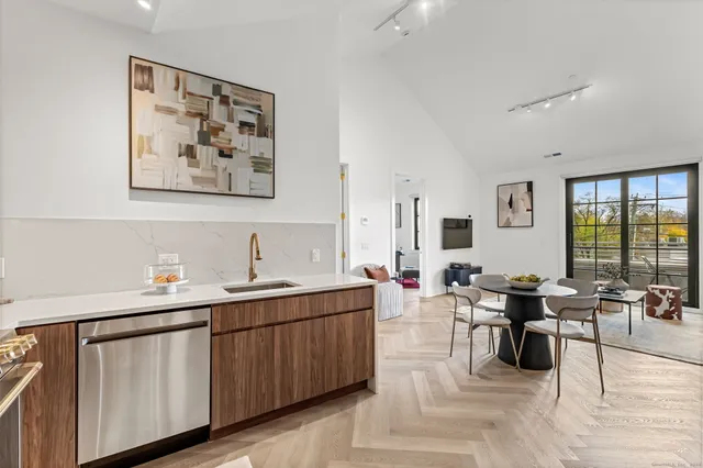 a living room with couches and painting on the wall