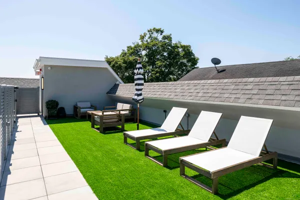 a view of backyard with sitting area